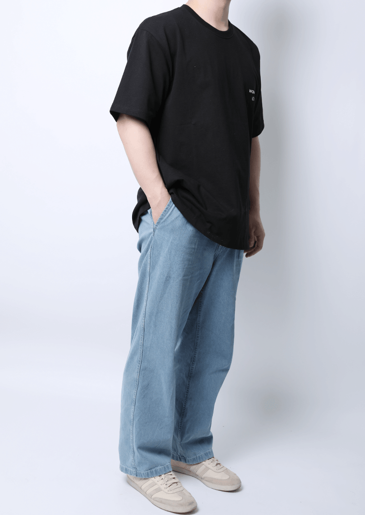 WaveWear men's athletic graphic t-shirt in black worn with light blue jeans and white sneakers