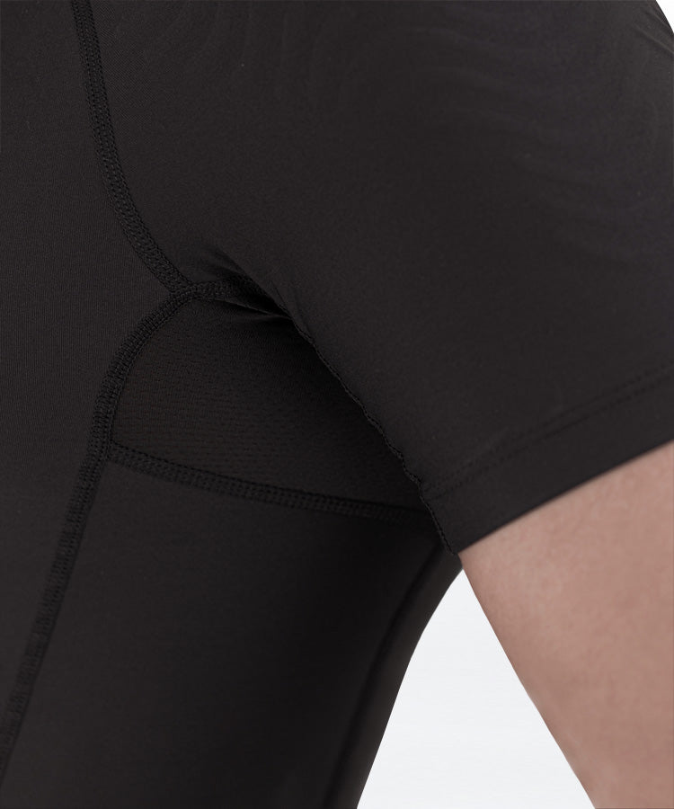 Close-up of black WaveWear men's compression top fabric and stitching on shoulder and sleeve