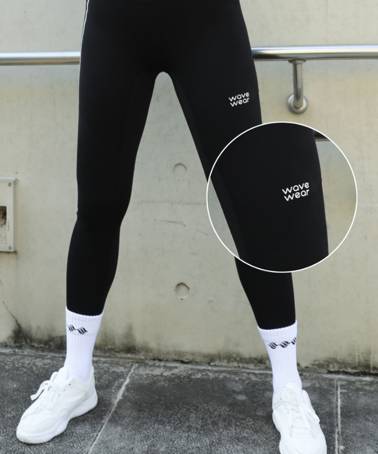 WaveWear black winter compression leggings women with logo on thigh worn with white socks and sneakers