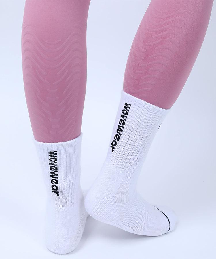 WaveWear white compression athletic socks worn on legs with textured pink leggings