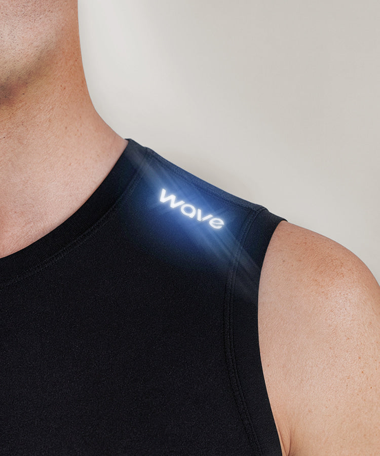R10 Sleeveless Compression Top close-up of illuminated Wave logo on chest showing premium branding detail