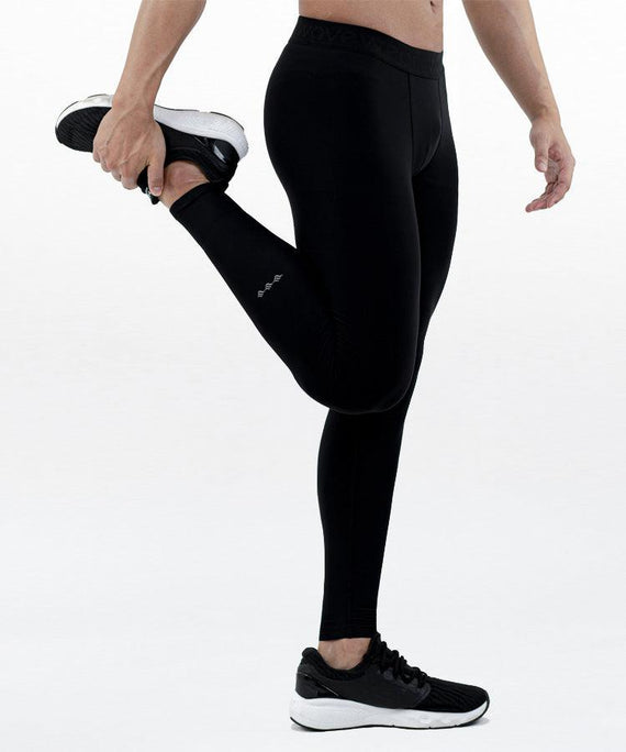 WaveWear black kinesiology tape leggings for men worn by man stretching leg with running shoes
