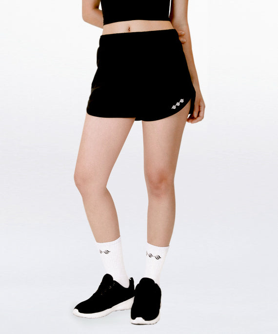 WaveWear black compression workout shorts for women paired with white socks and black athletic shoes