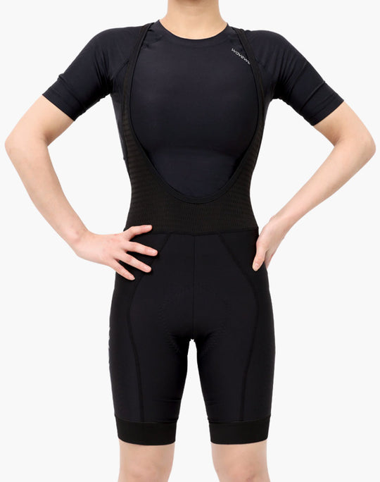 WaveWear black cycling bib shorts worn by model showcasing kinesiology tape cycling gear
