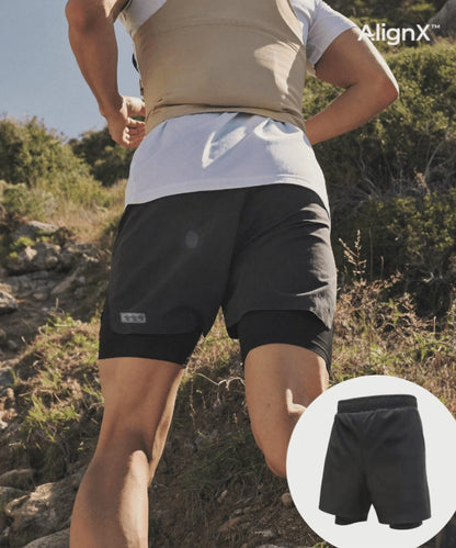 Man running on a trail in WaveWear 2-in-1 Kinesiology Running Shorts