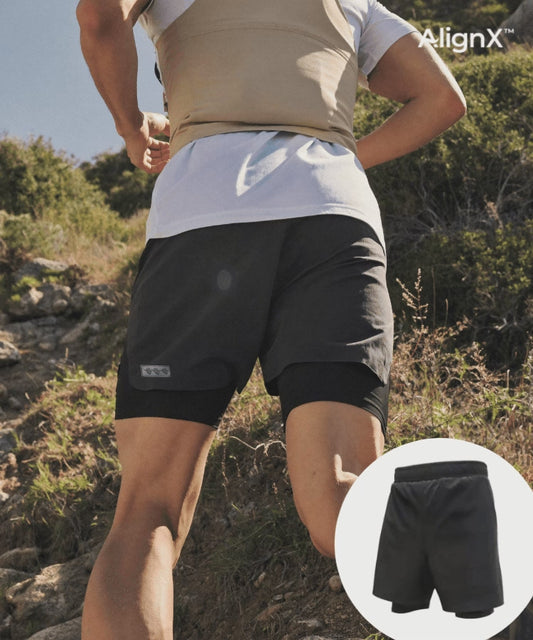 Man running on a trail in WaveWear 2-in-1 Kinesiology Running Shorts