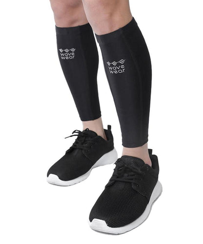 WaveWear C2 Calf Recovery Kinesiology Compression Sleeves in black worn to ankle length with sneakers showing WaveWear logo
