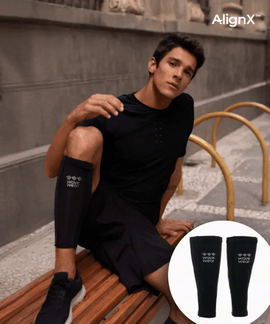 WaveWear C2 Calf Recovery Kinesiology Compression Sleeves on male model seated outdoors in black with product pair inset