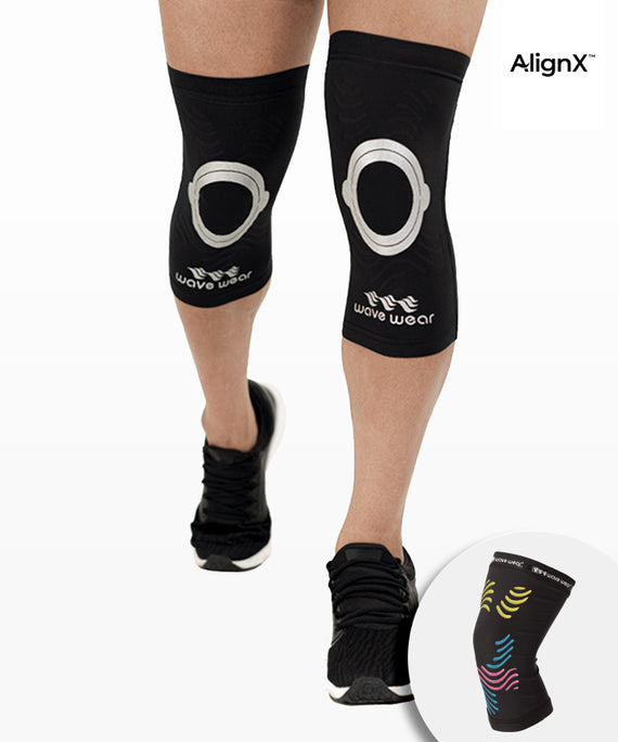 WaveWear kinesiology knee support sleeve in black worn on legs with circular knee design