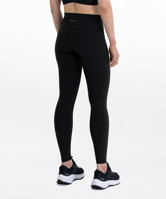 Zen Workout Compression Leggings Y1 back view on model in black showing high waist fit and wavewear logo on waistband with black sneakers