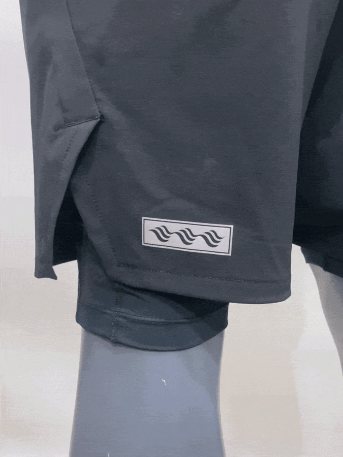 Close-up of the 2-in-1 shorts hem with the inner compression layer showing below the outer short