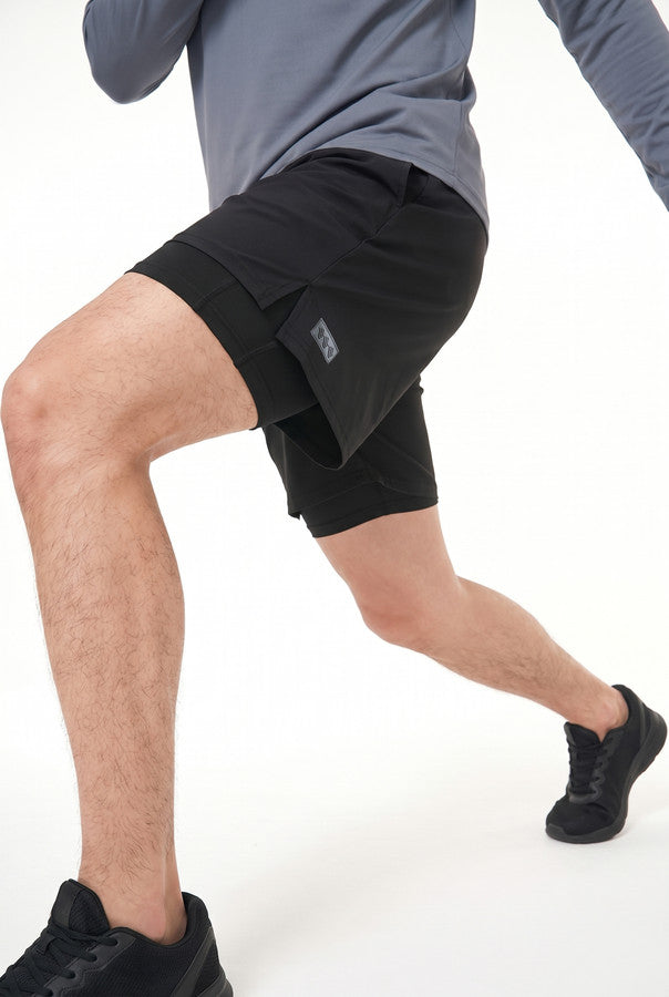 Runner in the 2-in-1 shorts mid-stride, inner layer visible below the outer short