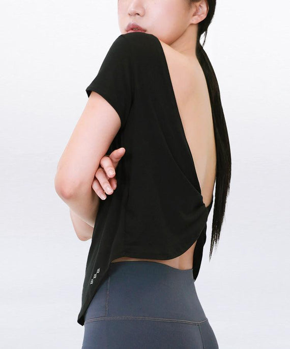 WaveWear black breathable gym shirt for women with open back design and short sleeves