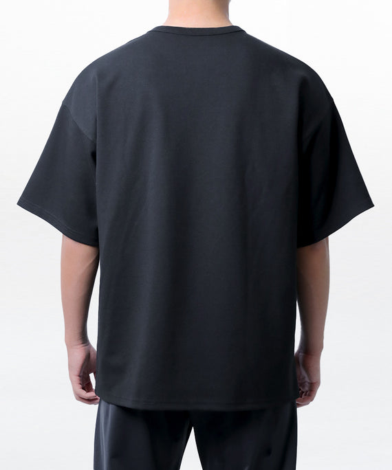Back view of a black dynamic oversized fit t-shirt by WaveWear worn by a model