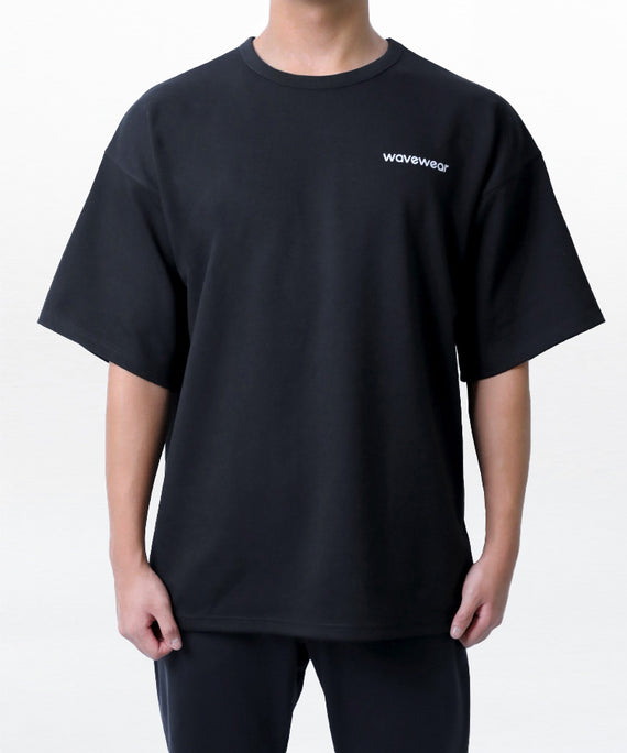 WaveWear black dynamic oversized fit t-shirt with short sleeves worn by model on white background