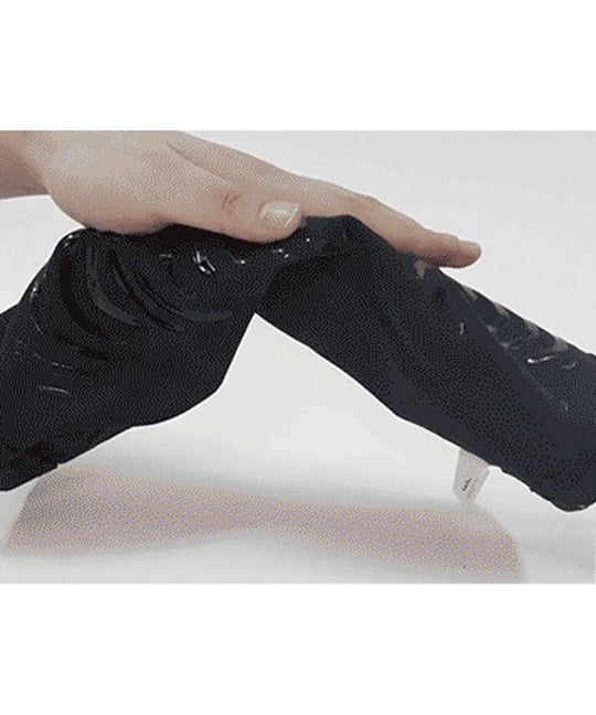 Black A1 ankle X-strap bent to demonstrate flexible pliable material with wave texture