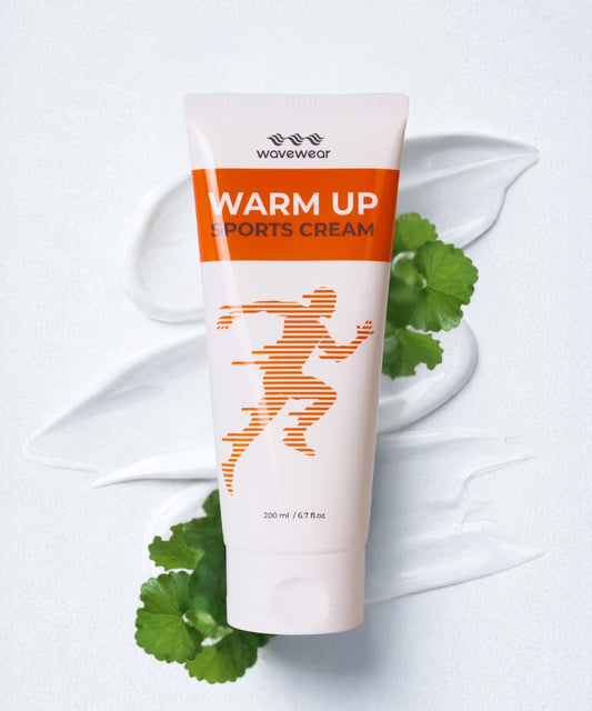 WaveWear Warm Up Sports Cream 200ml tube with orange runner graphic and fresh centella asiatica leaves on white background