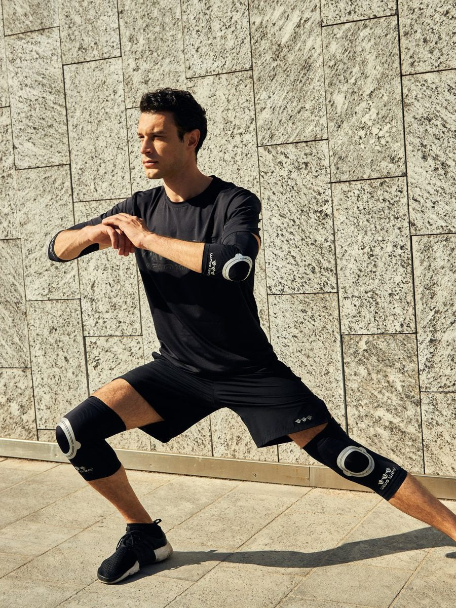 Man in a deep side lunge wearing WaveWear knee sleeves